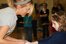 Kristin Waechter lends a hand during a volleyball clinic at the Baxter Neighborhood Center.