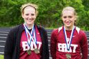 Kait Ervin (left) and Vanessa Legg combined for three gold medals at the KIAC track and field meet.