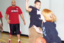 Noah Douglas (middle) and David Sanders (left) defend during a game with youngsters.