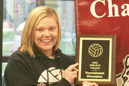 Madison Qualkenbush with the KIAC championship trophy and banner