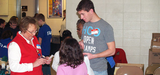 IU East runner Jon Strong (right) helps a young shopper make her list and check it twice.