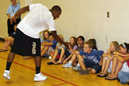 Terry Weathers congratulates a youngster for a good answer on July 19.