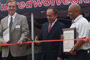 IU East Chancellor Nasser Paydar (middle) prepares to cut the ribbon to open IU East's new cross country course.