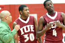 Coach Hester, Marcus Isaac (middle) and Huston Clark break down the action.