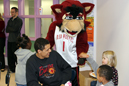 Brandon Muncie (left) and Rufus high-five students at Vaile Elementary.